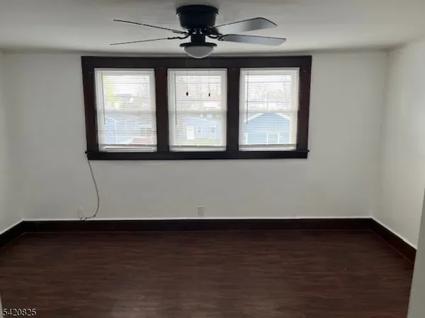 a view of a room with wooden floor and window