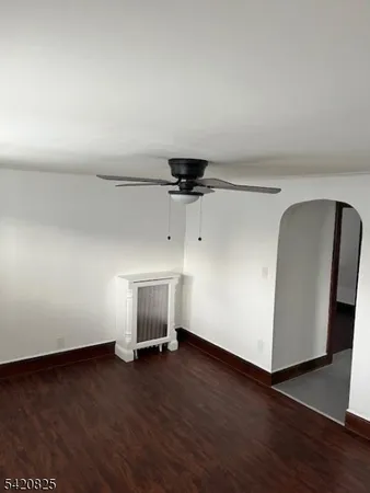 a view of a livingroom with wooden floor and a cabinet