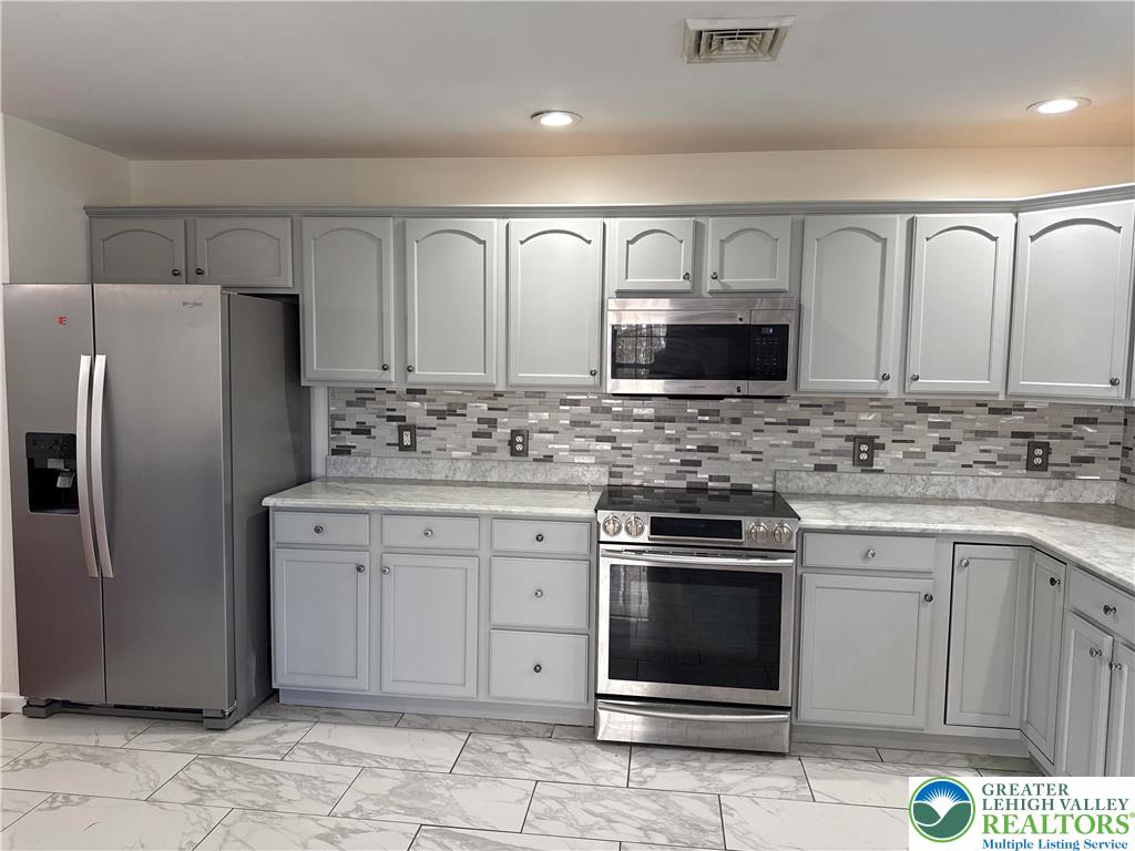 4141 Walter Road Bethlehem, PA 18020 - Photo 5 of 34 a kitchen with stainless steel appliances granite countertop a stove a sink and a refrigerator