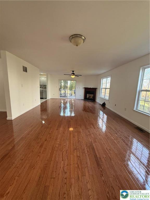 4141 Walter Road Bethlehem, PA 18020 - Photo 9 of 34 an empty room with wooden floor fireplace and windows