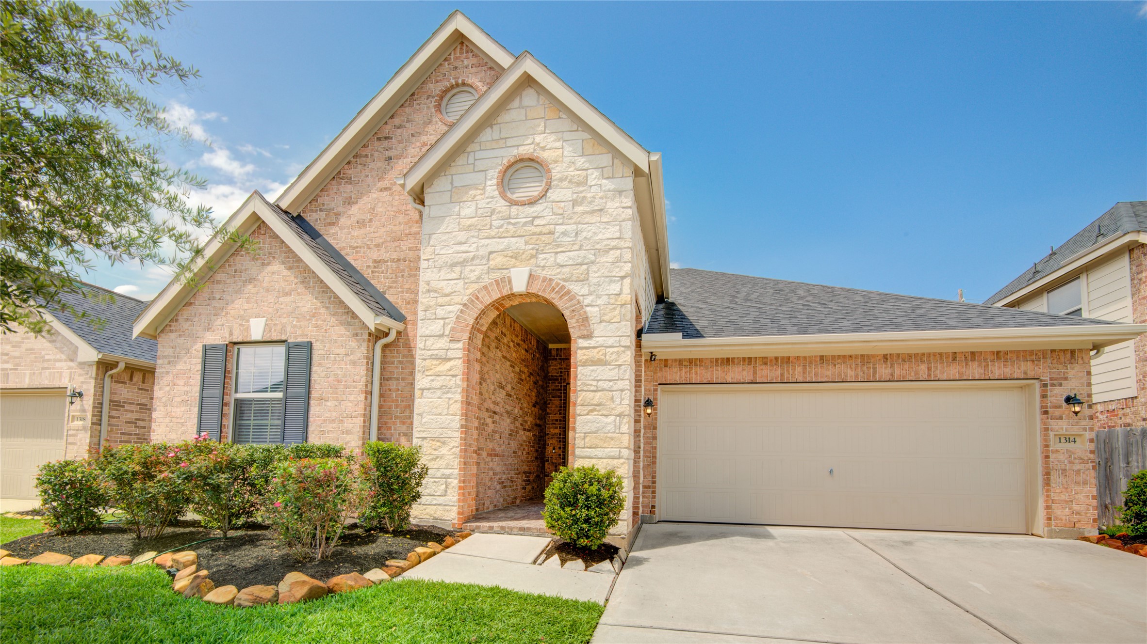 1314 Orchard Ridge Lane Tomball, TX 77375 - Photo 4 of 35 A warm, neutral exterior palette and clean architectural lines create a polished first impression with an attached two-car garage.