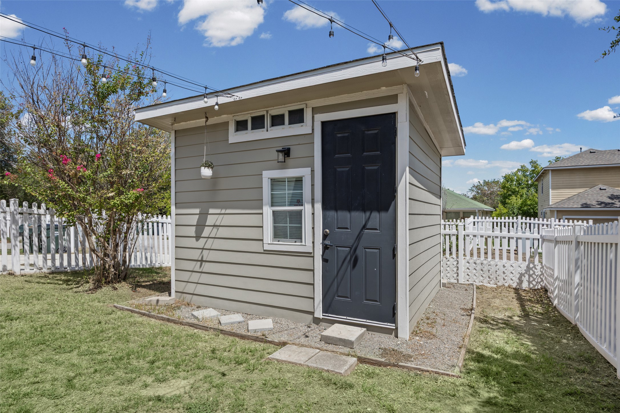 5881 Fergus Kyle, TX 78640 - Photo 34 of 40 A detached accessory structure sits within a fenced yard under sunny skies.