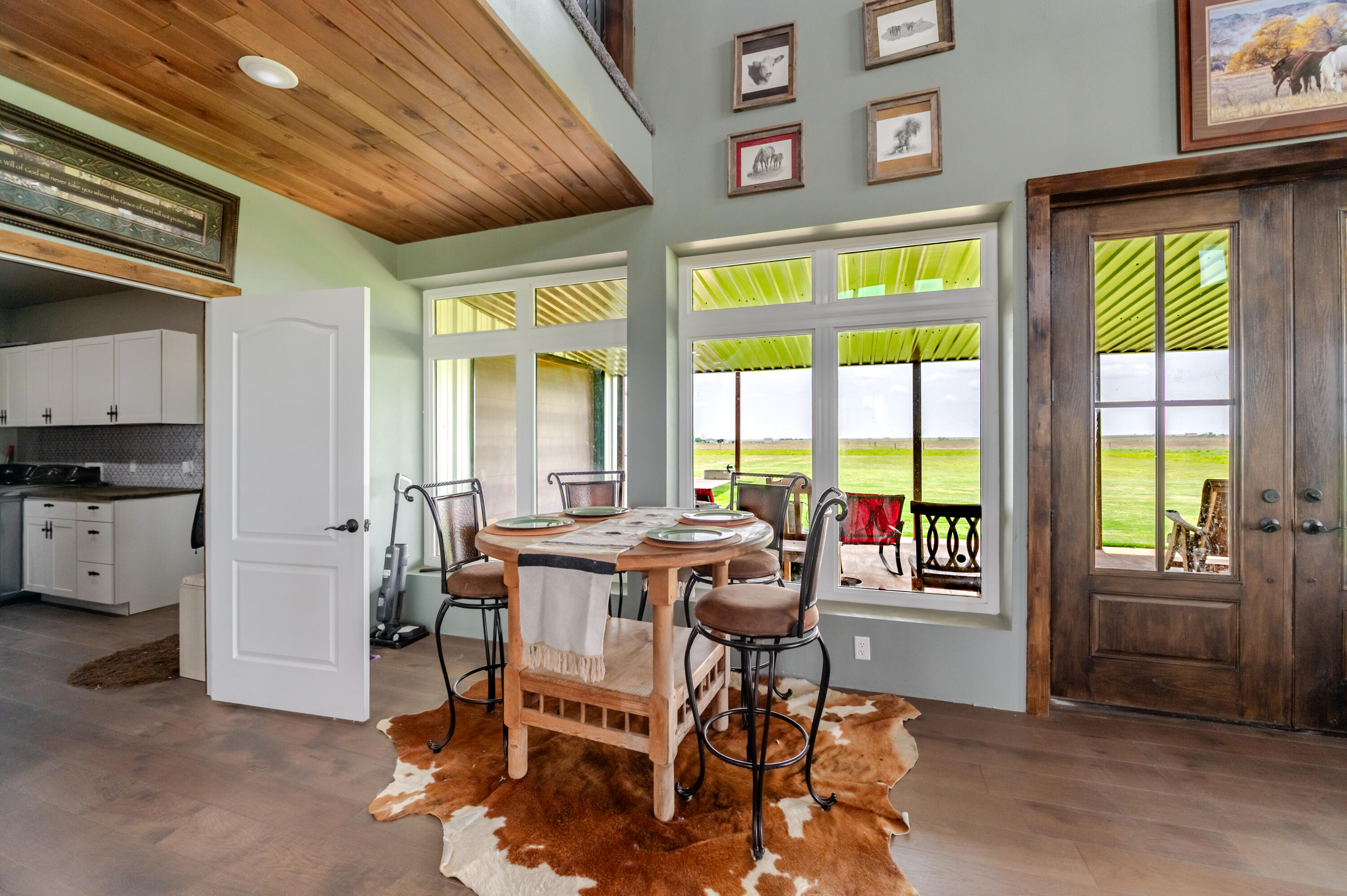 6792 Maine Road Anton, TX 79313 - Photo 30 of 77 a view of a dining room with furniture a chandelier and wooden floor