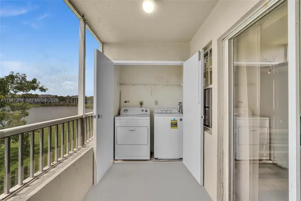 a view of a hallway with washer and dryer