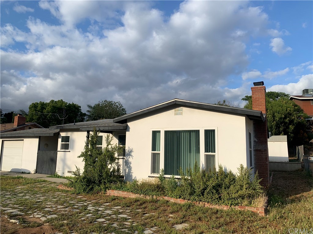 6565 Western Avenue Riverside, CA 92505 - Photo 1 of 1 a front view of a house with garden