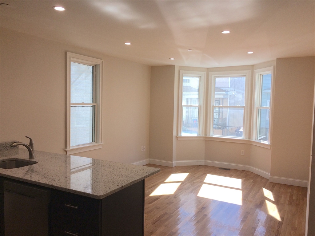 17 Plymouth Street, Unit 1 Cambridge, MA 02141 - Photo 2 of 6 a view of an empty room with a window