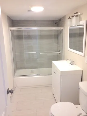 a bathroom with a sink toilet and shower
