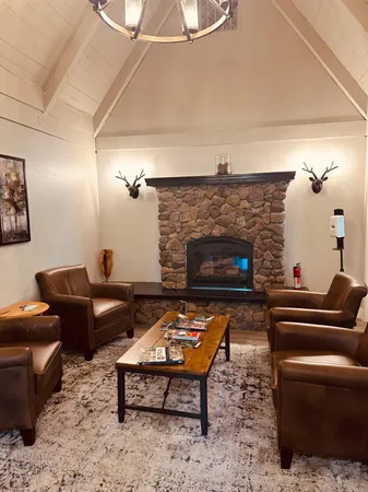 a living room with lots of furniture and a large window