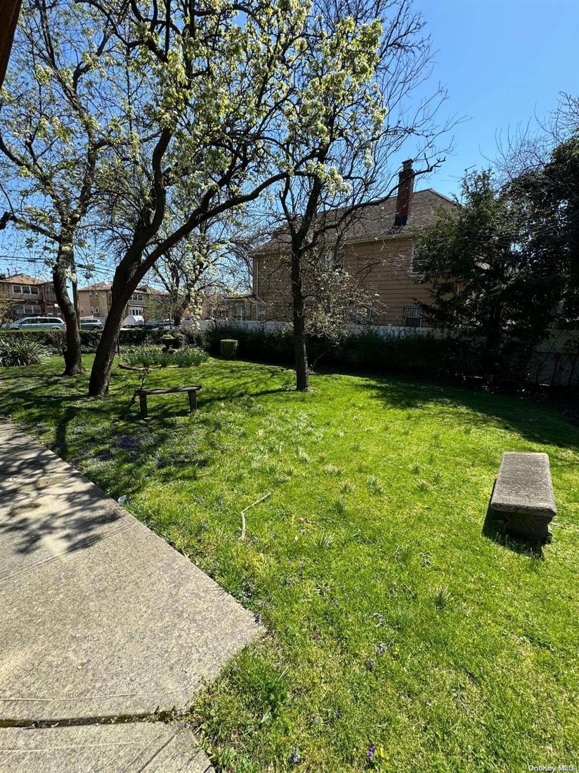 Ditmars Boulevard Manhattan, NY 10029 - Photo 3 of 8 a backyard of a house with lots of green space