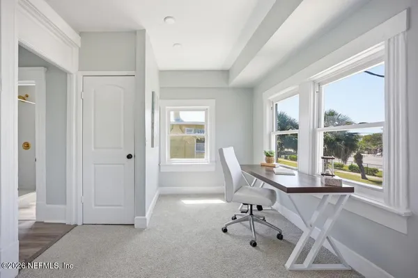 a bedroom with a bed and a chandelier fan