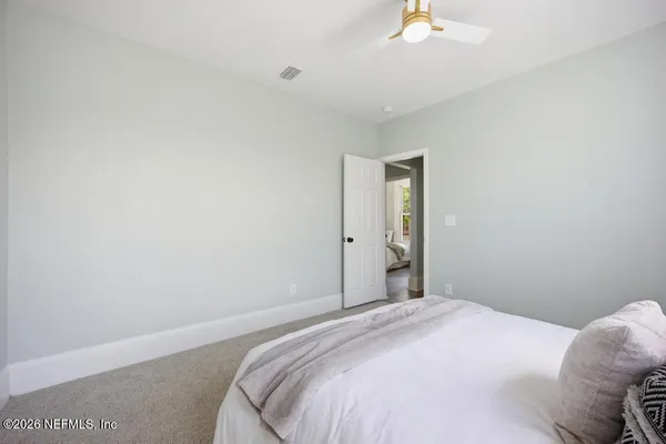 a living room with furniture and a painting on the wall