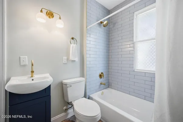 a living room with furniture a chandelier and a table