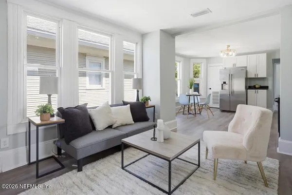 a living room with furniture and a potted plant