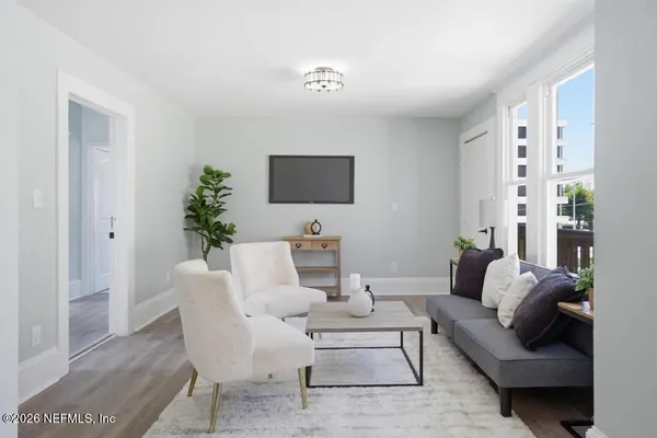 a living room with furniture and a flat screen tv