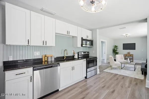 a bedroom with a bed and windows