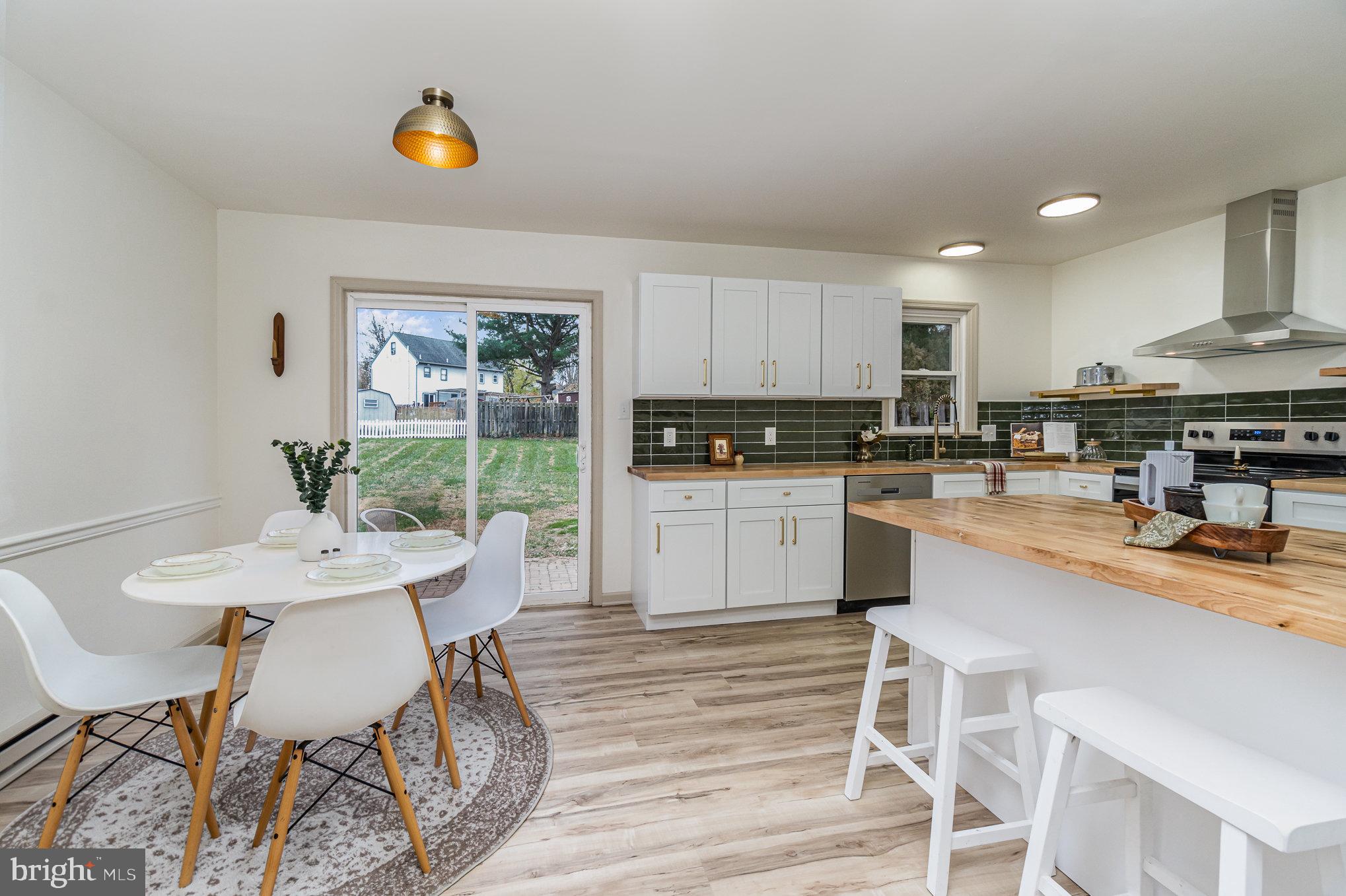 1638 Chadwick Circle Lancaster, PA 17603 - Photo 7 of 25 a kitchen with a table chairs a sink dishwasher stove and cabinets with wooden floor