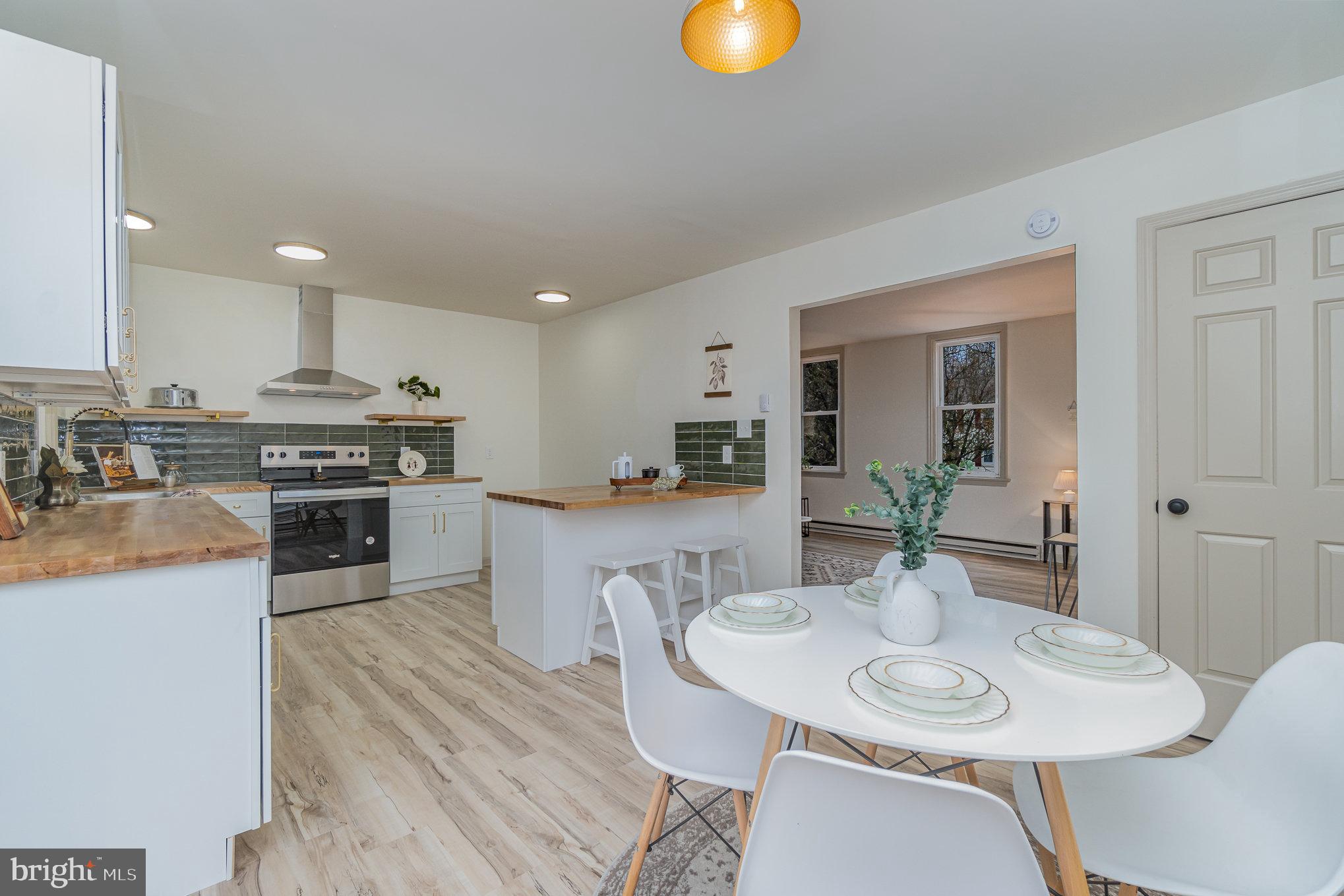 1638 Chadwick Circle Lancaster, PA 17603 - Photo 8 of 25 a kitchen with stainless steel appliances granite countertop a sink a stove a dining table and chairs