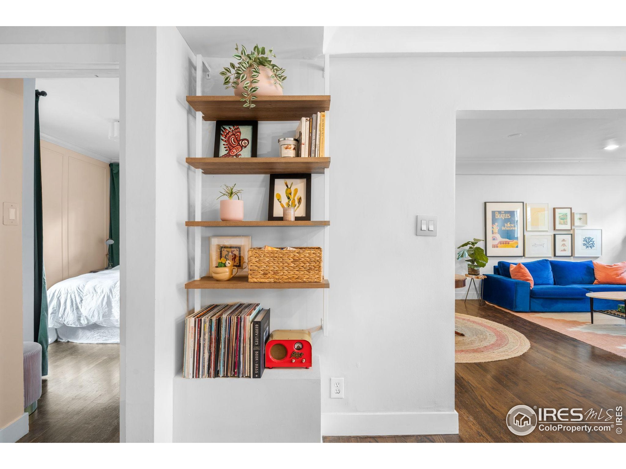 3359 Steele Street Denver, CO 80205 - Photo 11 of 48 a living room with furniture and a book shelf