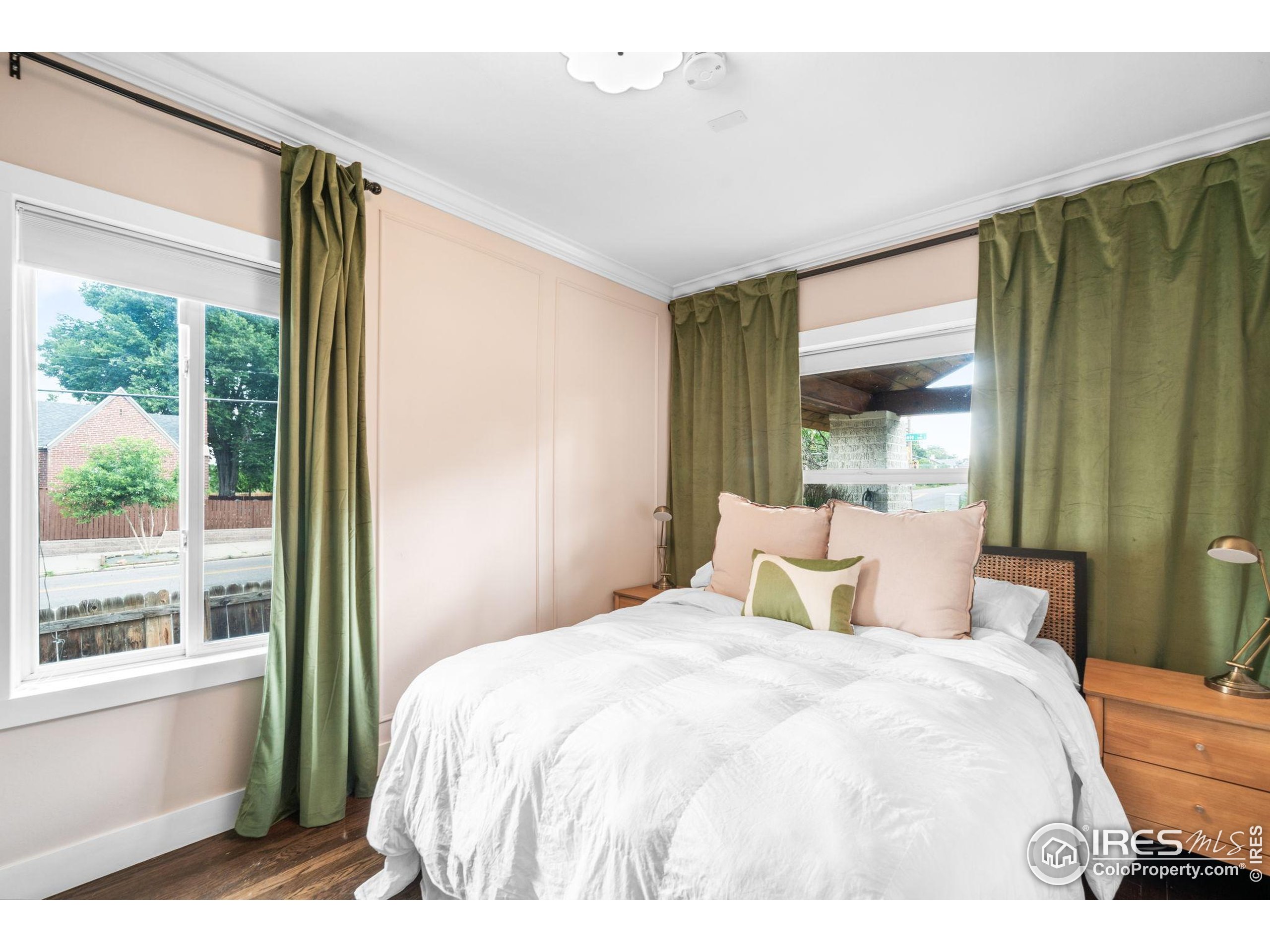 3359 Steele Street Denver, CO 80205 - Photo 14 of 48 a bedroom with a large bed and a large window