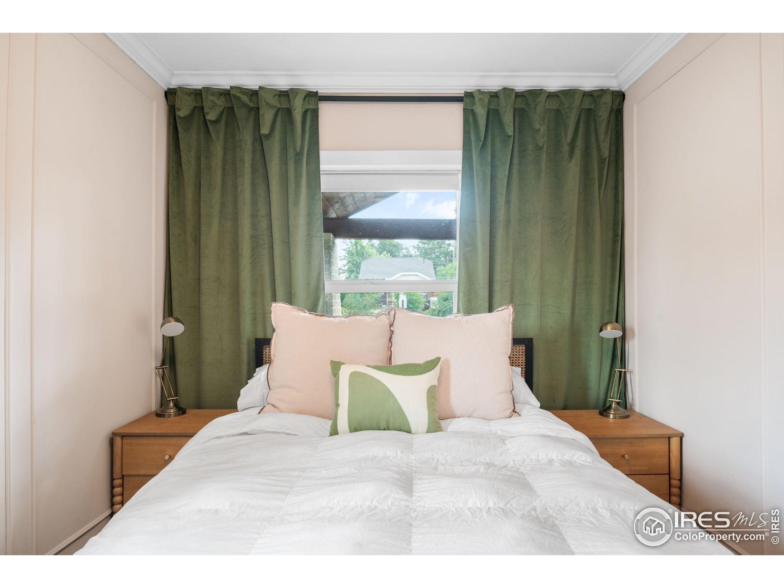 3359 Steele Street Denver, CO 80205 - Photo 16 of 48 a bed sitting in a bedroom next to a window