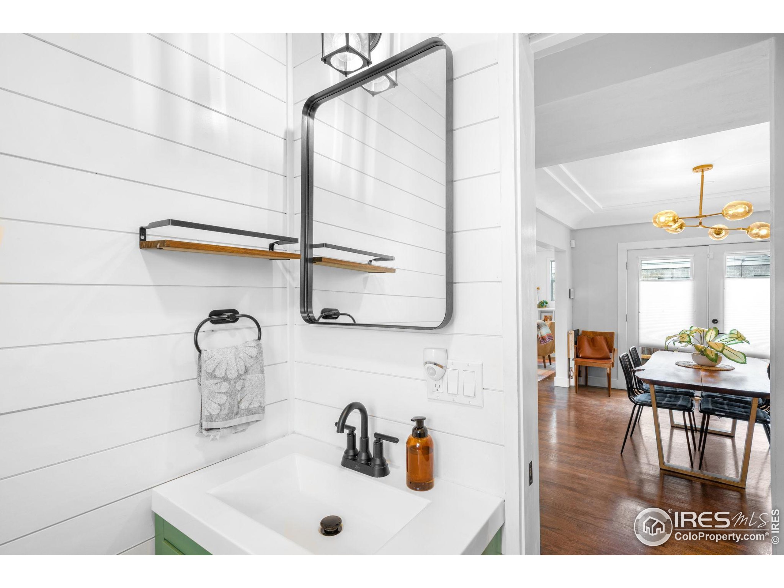 3359 Steele Street Denver, CO 80205 - Photo 17 of 48 a bathroom with a sink and a mirror