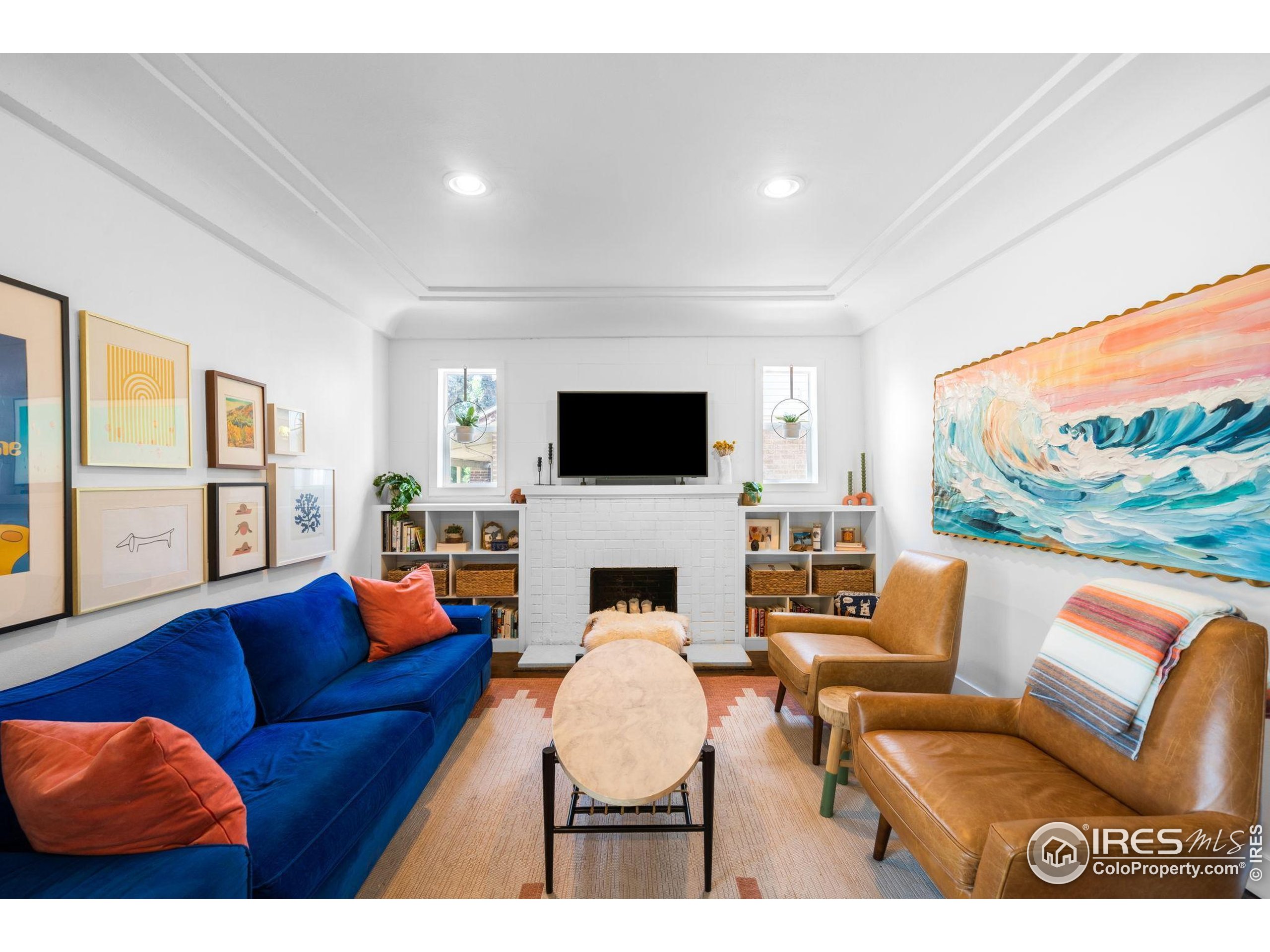 3359 Steele Street Denver, CO 80205 - Photo 2 of 48 a living room with furniture a fireplace and a flat screen tv