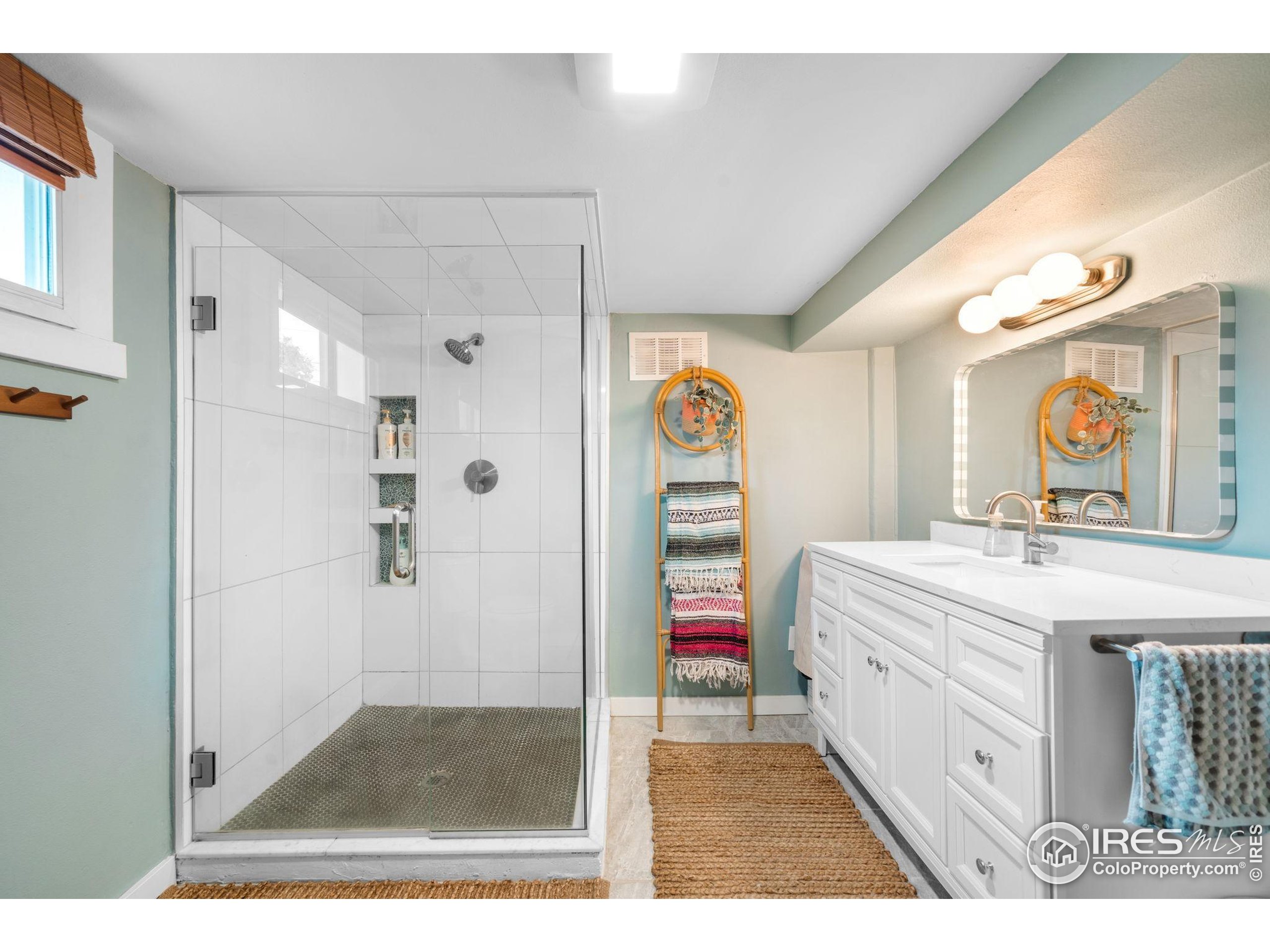 3359 Steele Street Denver, CO 80205 - Photo 21 of 48 a bathroom with a tub sink shower and mirror