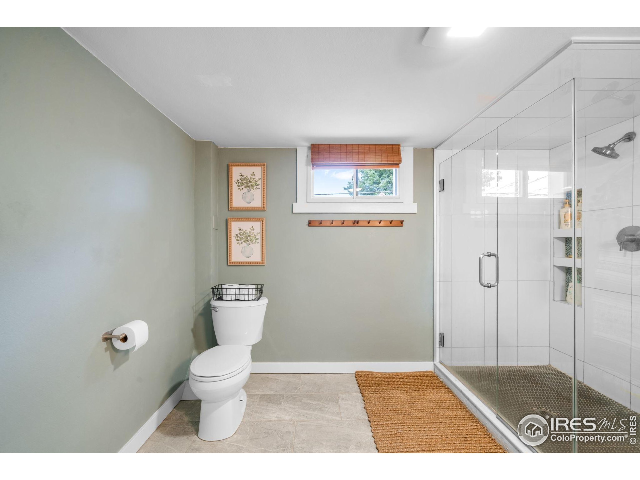 3359 Steele Street Denver, CO 80205 - Photo 22 of 48 a bathroom with a toilet and a shower