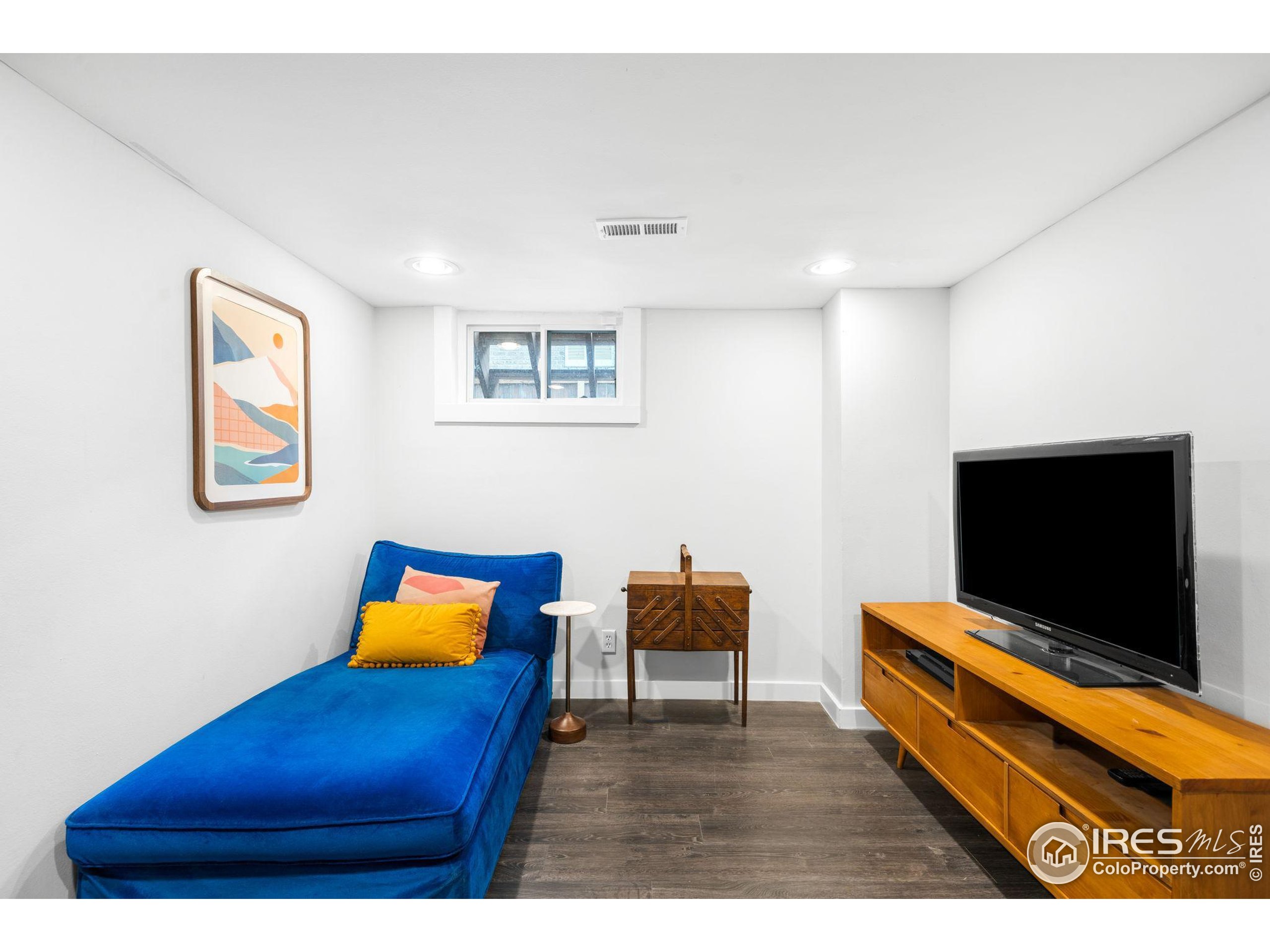 3359 Steele Street Denver, CO 80205 - Photo 24 of 48 a living room with furniture and a flat screen tv