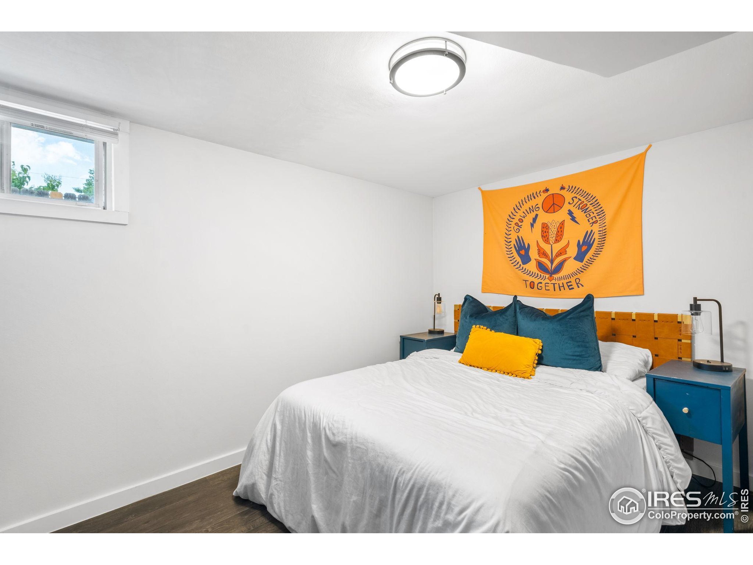 3359 Steele Street Denver, CO 80205 - Photo 25 of 48 a bedroom with a bed and blue walls