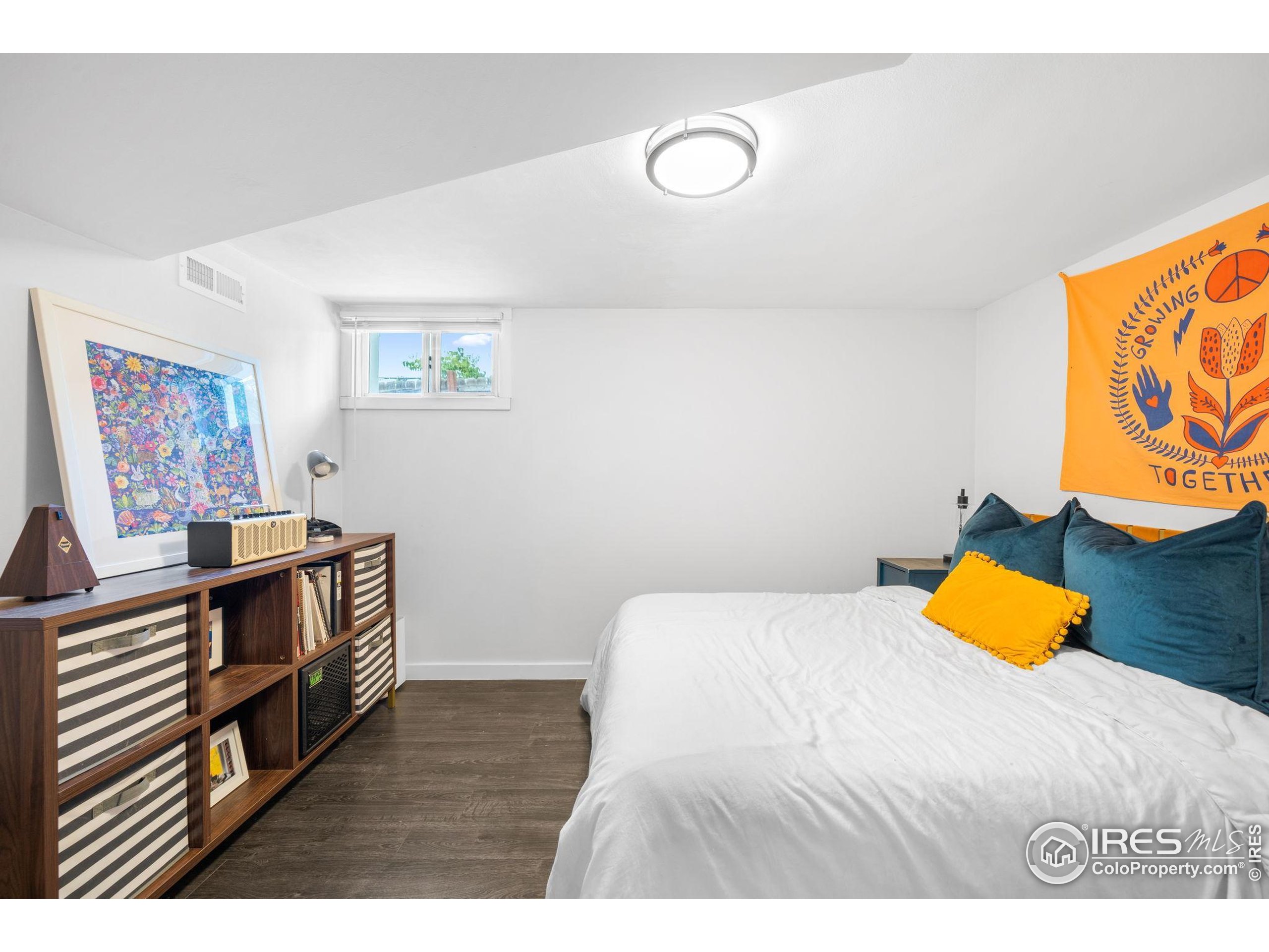 3359 Steele Street Denver, CO 80205 - Photo 26 of 48 a bedroom with a bed and painting on the wall