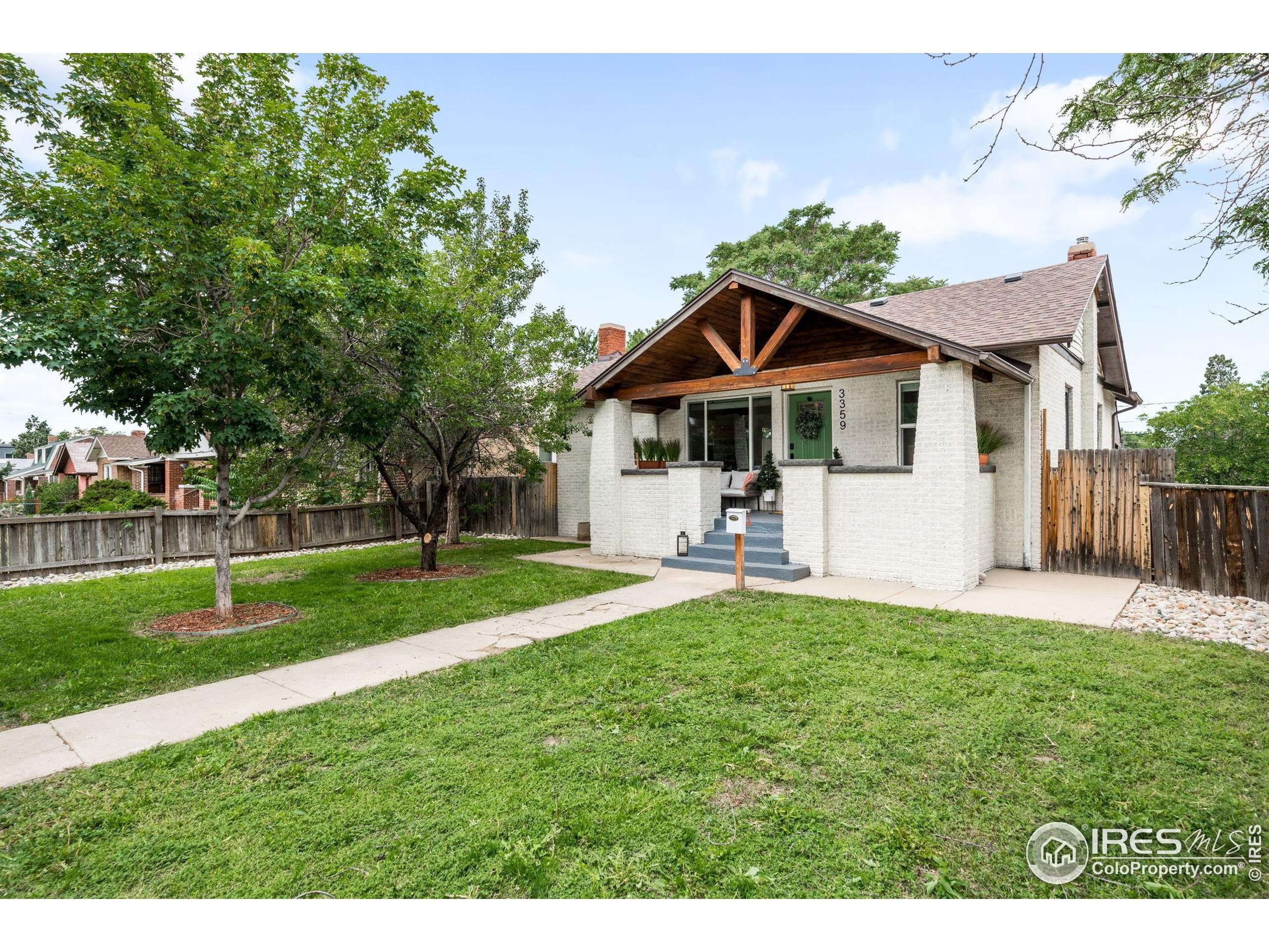 3359 Steele Street Denver, CO 80205 - Photo 35 of 48 a view of a house with a yard and sitting area