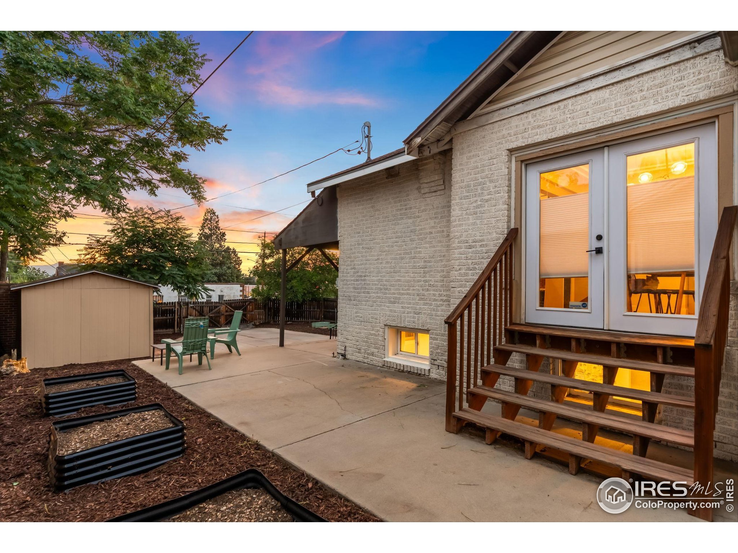 3359 Steele Street Denver, CO 80205 - Photo 37 of 48 a backyard of a house with barbeque oven table and chairs