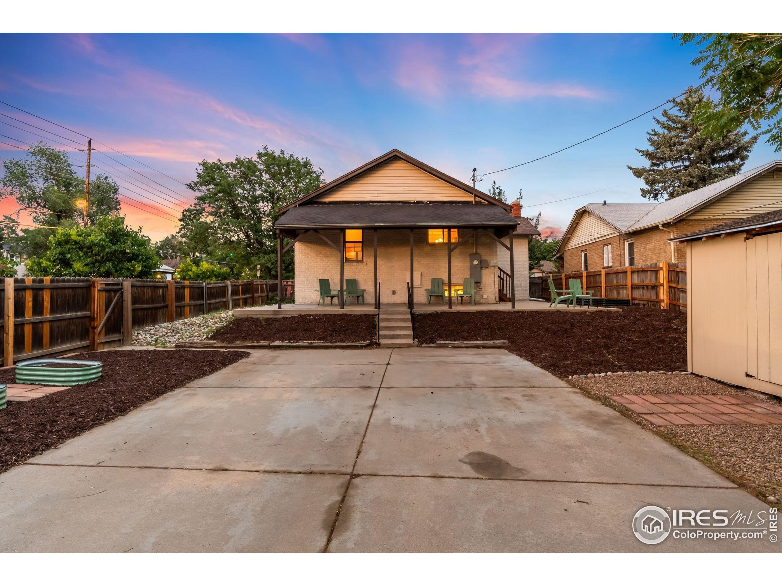 3359 Steele Street Denver, CO 80205 - Photo 38 of 48 a view of house and outdoor space with yard