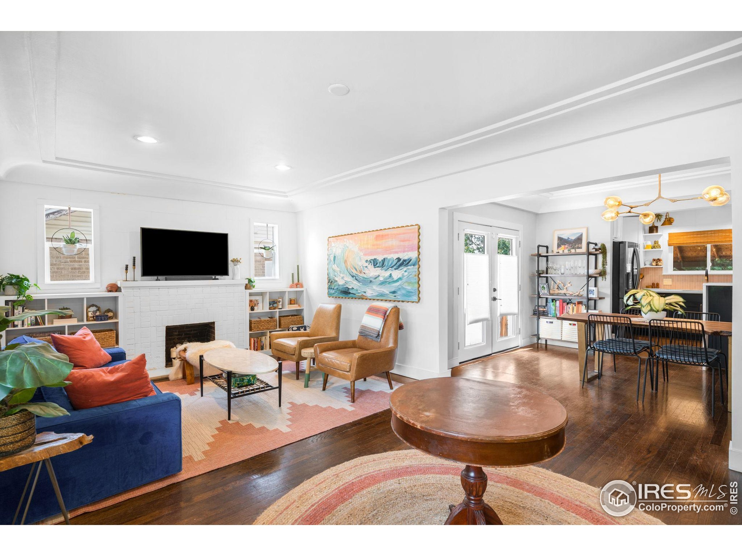 3359 Steele Street Denver, CO 80205 - Photo 4 of 48 a living room with furniture and a flat screen tv