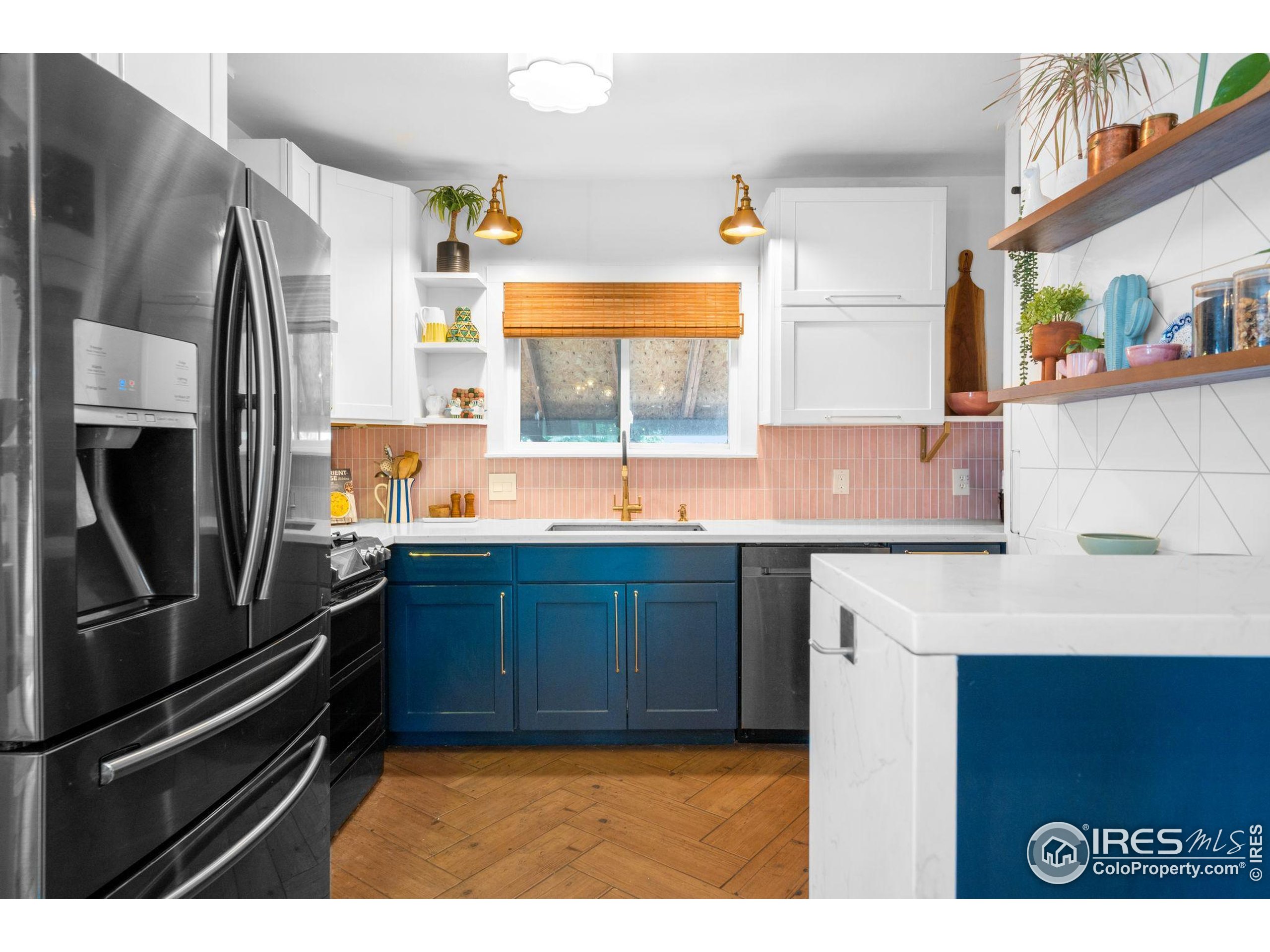 3359 Steele Street Denver, CO 80205 - Photo 5 of 48 a kitchen with granite countertop a sink stainless steel appliances and cabinets