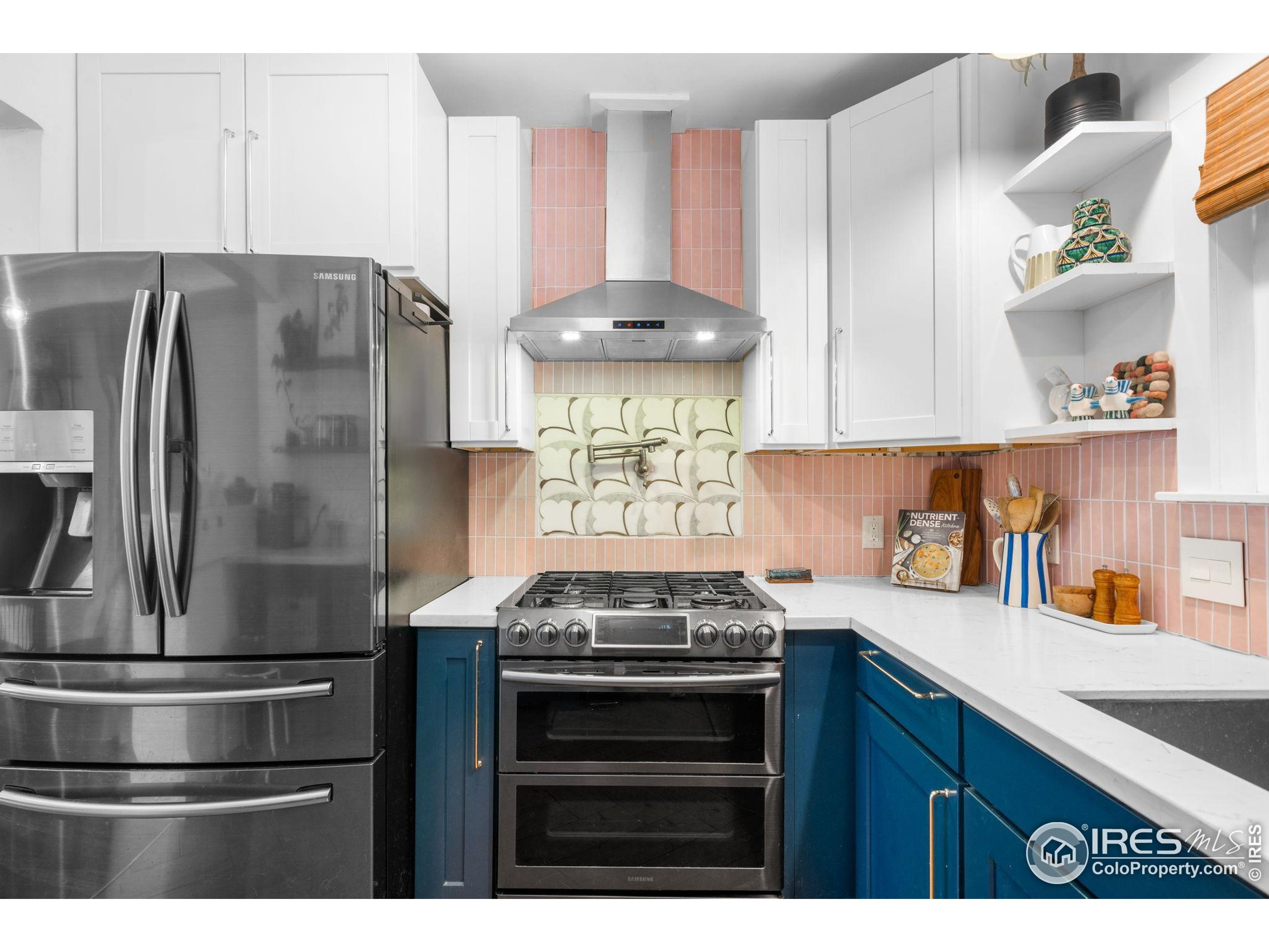 3359 Steele Street Denver, CO 80205 - Photo 7 of 48 a kitchen with stainless steel appliances granite countertop a stove and a refrigerator