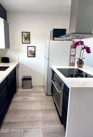 a kitchen with a sink and a stove top oven