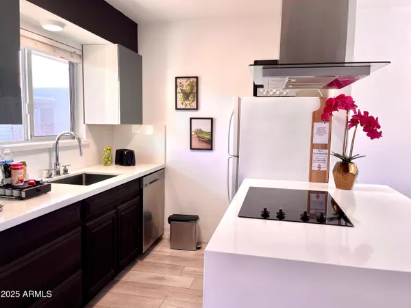 a kitchen with a refrigerator and a sink