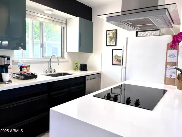 a kitchen with a sink a large window and stainless steel appliances
