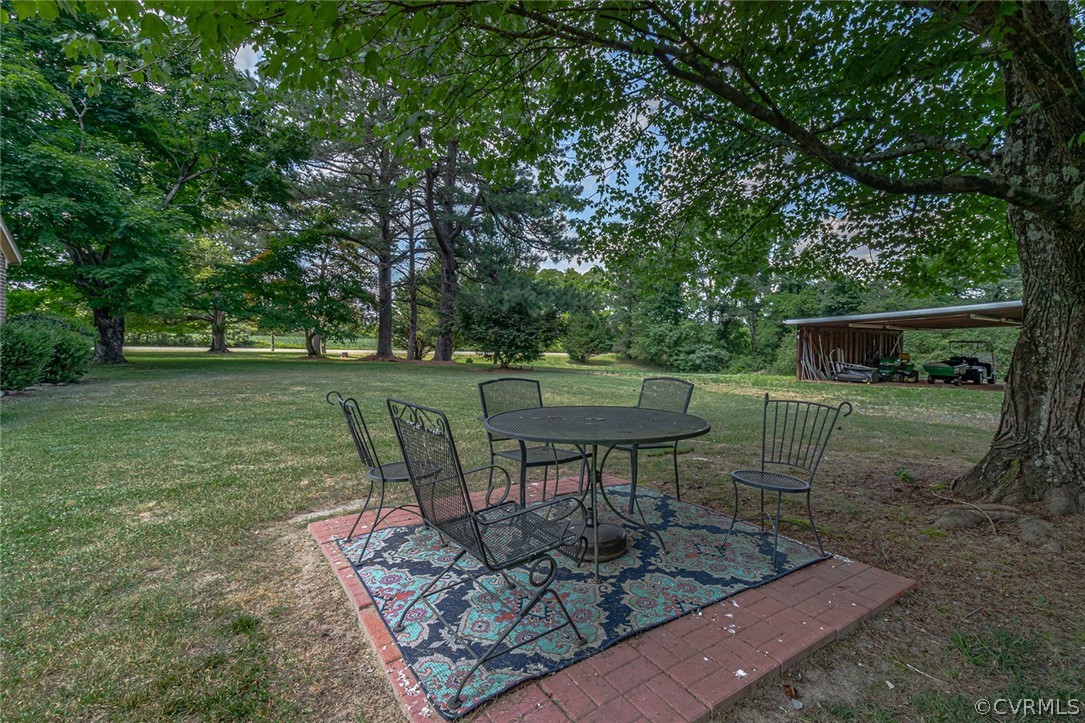 31 Bunker Hill Road Farnham, VA 22460 - Photo 43 of 47 a view of a backyard with table and chairs potted plants and large trees