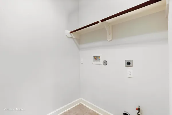 a view of a livingroom with a fireplace a ceiling fan and windows