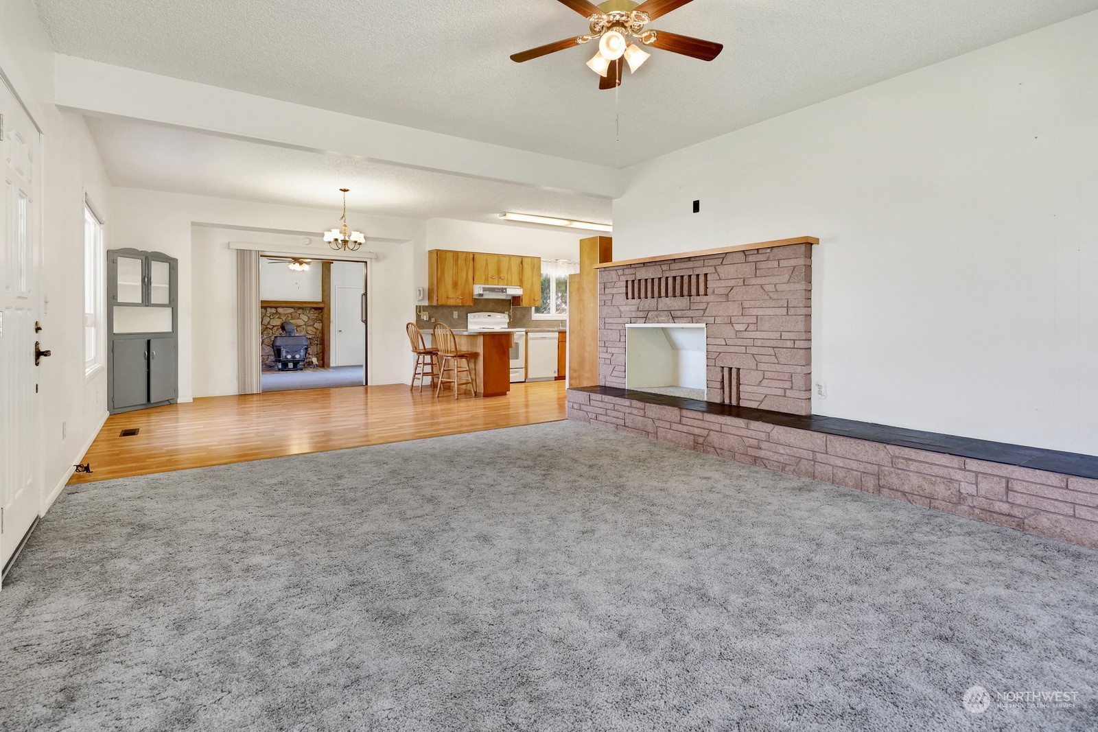 1705 Pangborn Road Lynden, WA 98264 - Photo 17 of 40 an empty room with chandelier fan and fireplace