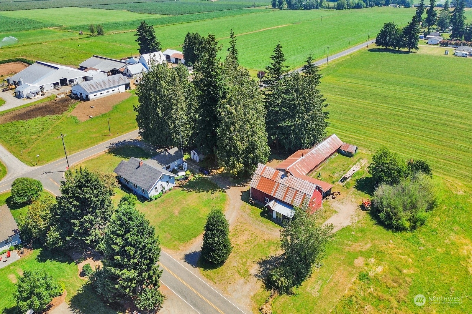 1705 Pangborn Road Lynden, WA 98264 - Photo 2 of 40 an aerial view of a house with a garden and swimming pool