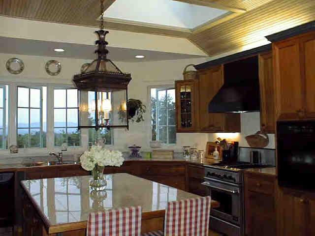 165 Perry Peak Road Richmond, MA 01254 - Photo 3 of 7 a kitchen with stainless steel appliances a stove a table and chairs in it