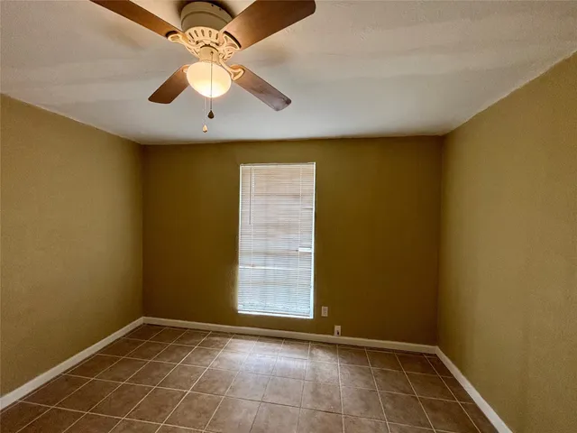 an empty room with closet and fan