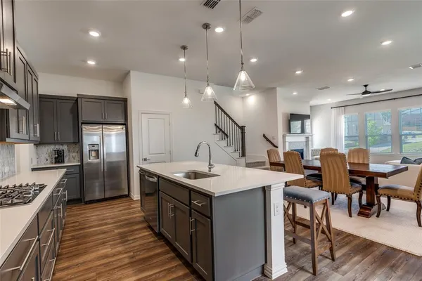 a large kitchen with a table and chairs