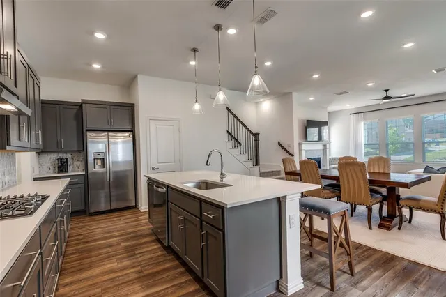a large kitchen with a table and chairs