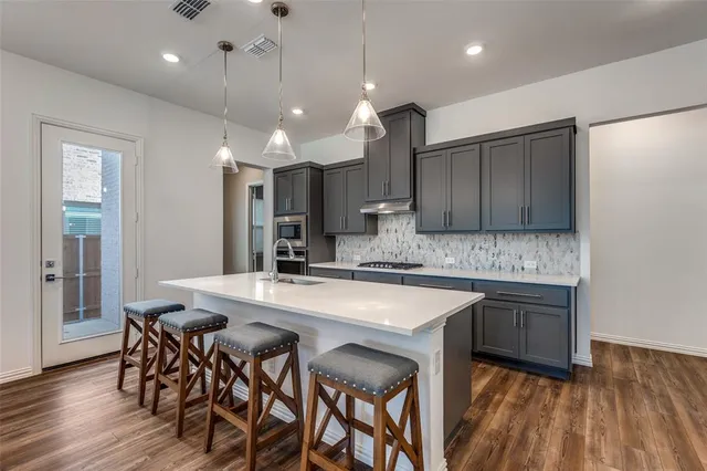 a kitchen with a table and chairs in it