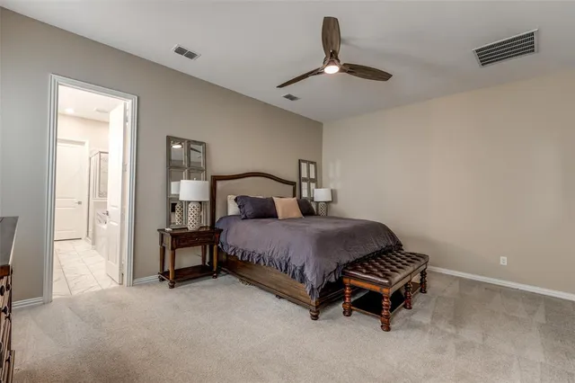 a bedroom with a bed and a ceiling fan